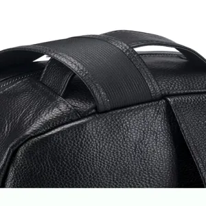 Close-up detail of genuine leather men backpack strap and handle texture, premium black cowhide.