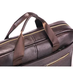 Genuine leather business briefcase detail shot, brown men's laptop bag with metal zippers.