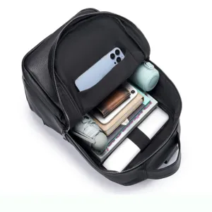 Detailed view of black genuine leather backpack interior with organized storage compartments.