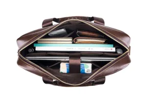 Top-down interior detail of brown leather briefcase, showing organized laptop and book pockets.