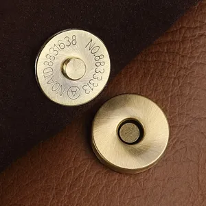 Close-up detail of brass magnetic snap button for leather bags hardware accessory part