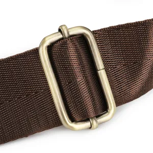 Brown bag strap metal slider buckle detail close-up, durable nylon webbing accessory view