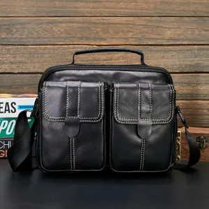 Black genuine leather men business casual messenger bag detail view with front pockets.