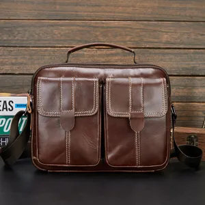 Brown genuine leather men messenger bag featuring double front pockets and top handle for business.