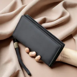 Detail shot of men's leather long wallet with wrist strap, elegant presentation.
