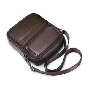 Close-up view of dark brown leather men crossbody bag showing details and pockets.