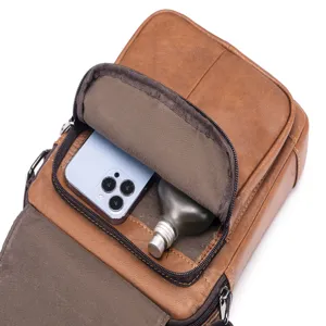 Detail view of genuine leather men's vertical crossbody bag showing interior pocket capacity.