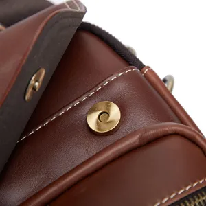 Men vintage leather crossbody bag detail closeup showing fine stitching and metal clasp.