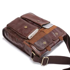 Close-up detail of retro oil wax leather men shoulder messenger bag with multiple front pockets.