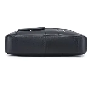 Black genuine leather business briefcase bottom and side detail view, premium cowhide material.