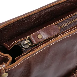 Leather laptop bag detail, vintage oil-wax messenger bag zipper and texture close-up.