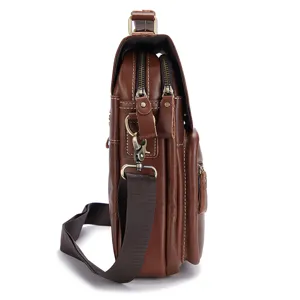 Close-up side view of brown leather men messenger bag showing fine zipper hardware and texture.