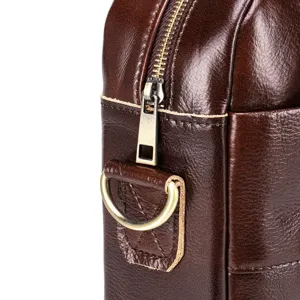Detail view of men's genuine leather briefcase, dark brown texture, zipper hardware.