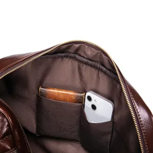 Detailed view of genuine leather men's briefcase interior, showing multiple storage pockets.