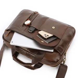 Leather briefcase detail showing spacious compartments, premium texture and durable hardware.