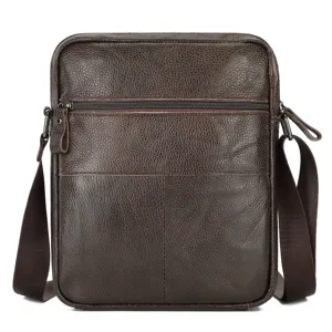 Detailed close-up view of men's brown genuine leather crossbody bag texture and front zipper pocket.