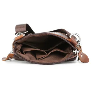 Detail view of men's leather crossbody bag interior pockets and lining structure.