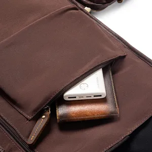 Leather garment bag interior pocket detail showing storage capacity for travel accessories.