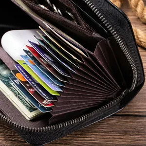 Black leather long wallet detail view, showing multi-card slots and zipper compartment.
