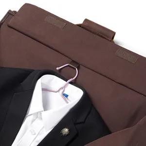 Detailed view of the folding suit travel bag, showing the interior hanger and high-end leather details.