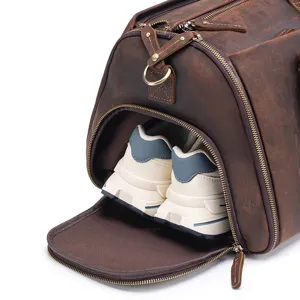 Genuine leather travel duffel bag detail showing separate shoe compartment for gym trips.