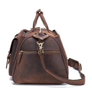 Detail view of genuine leather travel duffel bag, showing hardware and retro texture features.