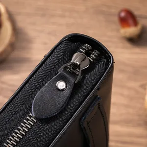 Close-up detail of black leather men wallet metal zipper and premium texture surface