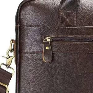 Close-up detail of men's genuine leather briefcase, vintage brown cowhide texture zipper