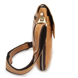Detail shot of men genuine leather messenger bag side view with fabric strap and metal zipper.