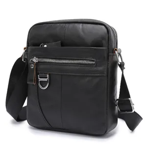 Detail shot of black leather men crossbody bag showing front zipper pocket and metal hardware.