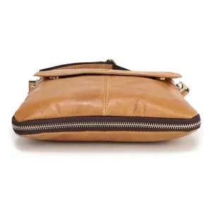 Close-up detail of genuine leather men's vertical shoulder bag bottom zipper expansion design.