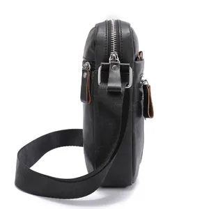 Detailed view of black leather men crossbody messenger bag showing metal zipper and durable strap