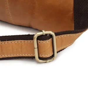 Close-up detail of genuine leather men bag strap with durable metal buckle and fine stitching.