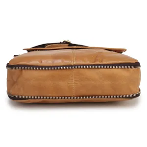 Men's genuine leather shoulder bag detail close-up showing durable zippers and premium brown cowhide.