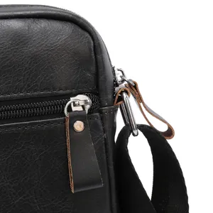 Close-up detail of men's genuine leather messenger bag zipper and strap attachment hardware.