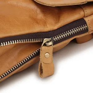 Detailed closeup of genuine leather men shoulder bag zipper, premium brown cowhide texture.