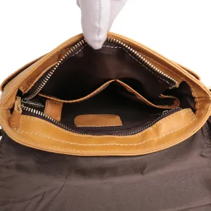 Detailed view of the genuine leather men's messenger bag interior compartments and storage.