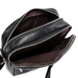 Top grain leather men crossbody bag detail view showing multi zippered pockets and lining.