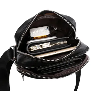 Detail view of black leather men messenger bag interior capacity multi pocket storage design