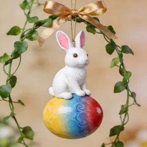 Easter bunny hanging ornament, white rabbit on colorful egg with gold ribbon and green vine.