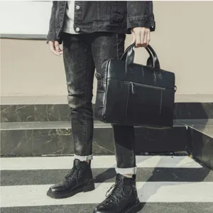 Detail view of black leather business briefcase for men, stylish casual messenger bag for daily use.