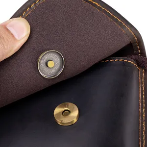 Close-up detail of genuine crazy horse leather men's bag magnetic snap button hardware.