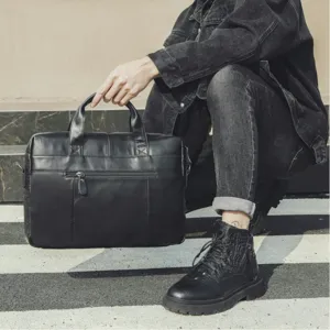 Genuine leather business briefcase detail view showing texture, zippers and handles.