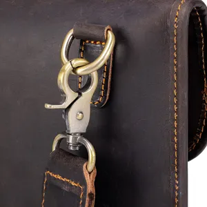 Closeup detail of men vintage crazy horse leather shoulder bag hardware and heavy stitching.