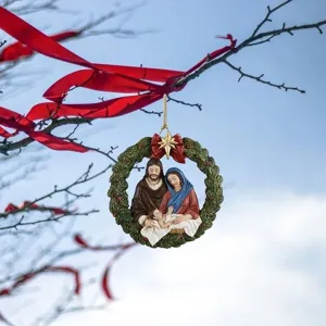 Christmas Nativity scene wreath hanging ornament detail view showing holy family sculpture.