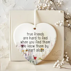 Ceramic heart ornament with friendship quote and floral design, ideal home hanging decor.