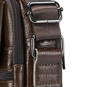 Detailed close-up of mens brown genuine leather shoulder bag strap hardware and metal buckle.