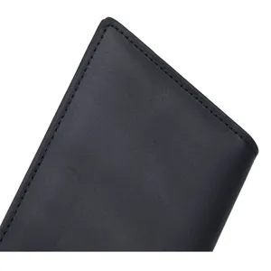 Close-up detail of black genuine leather wallet edge with fine stitching craftsmanship.