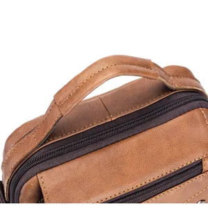 Close-up detail of premium brown leather men's business bag showing durable handle and zip.