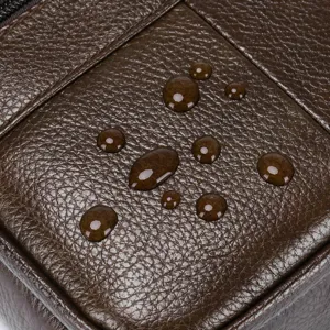 Close-up detail view of waterproof top-layer cowhide leather men bag showing texture.